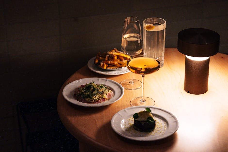 Sophisticated dining setup with gourmet dishes and drinks.