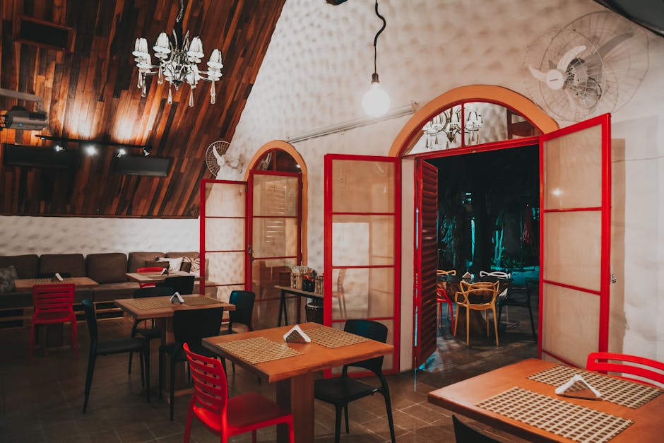 Warm and inviting restaurant interior featuring wooden details and red accents.
